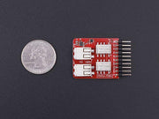 Tessel Relay Module front view with size comparison to a coin